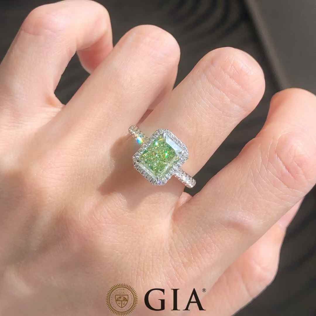 Radiant cut 2.54ct greenish yellow diamond ring with white diamond halo in 18k white gold