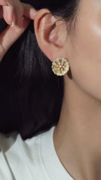 Elegant 18K gold brushed flower stud earrings featuring 1.44 carats of natural diamonds.