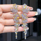 Luxurious 18K gold drop earrings featuring a rare 3.828-carat intense yellow diamond with 2.162 carats of accent diamonds.