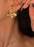 Large butterfly-style ear clips in brushed 18K yellow gold featuring 1.21 carats of natural diamonds.