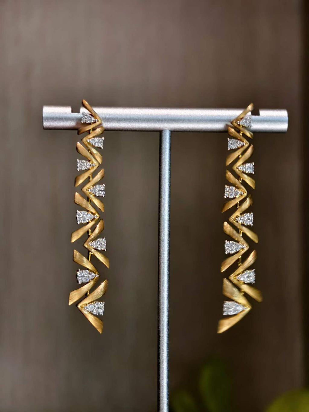 Close-up detail of elegant 18K yellow gold drop earrings featuring natural diamonds totaling 0.62 carats.