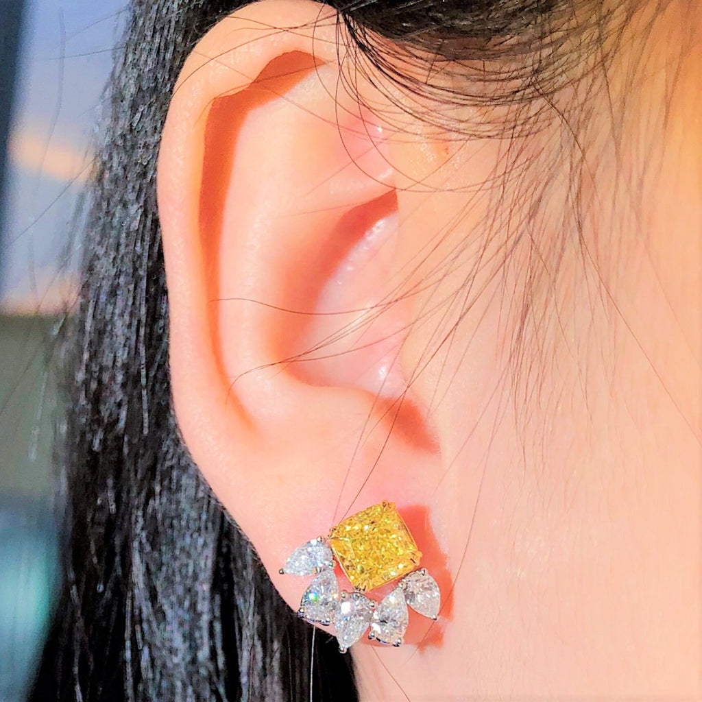 3.94ct fancy yellow and white diamond stud earrings in 18k white gold
