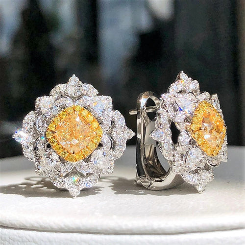 “3.78ct fancy yellow and white diamond stud earrings in 18k white and yellow gold”