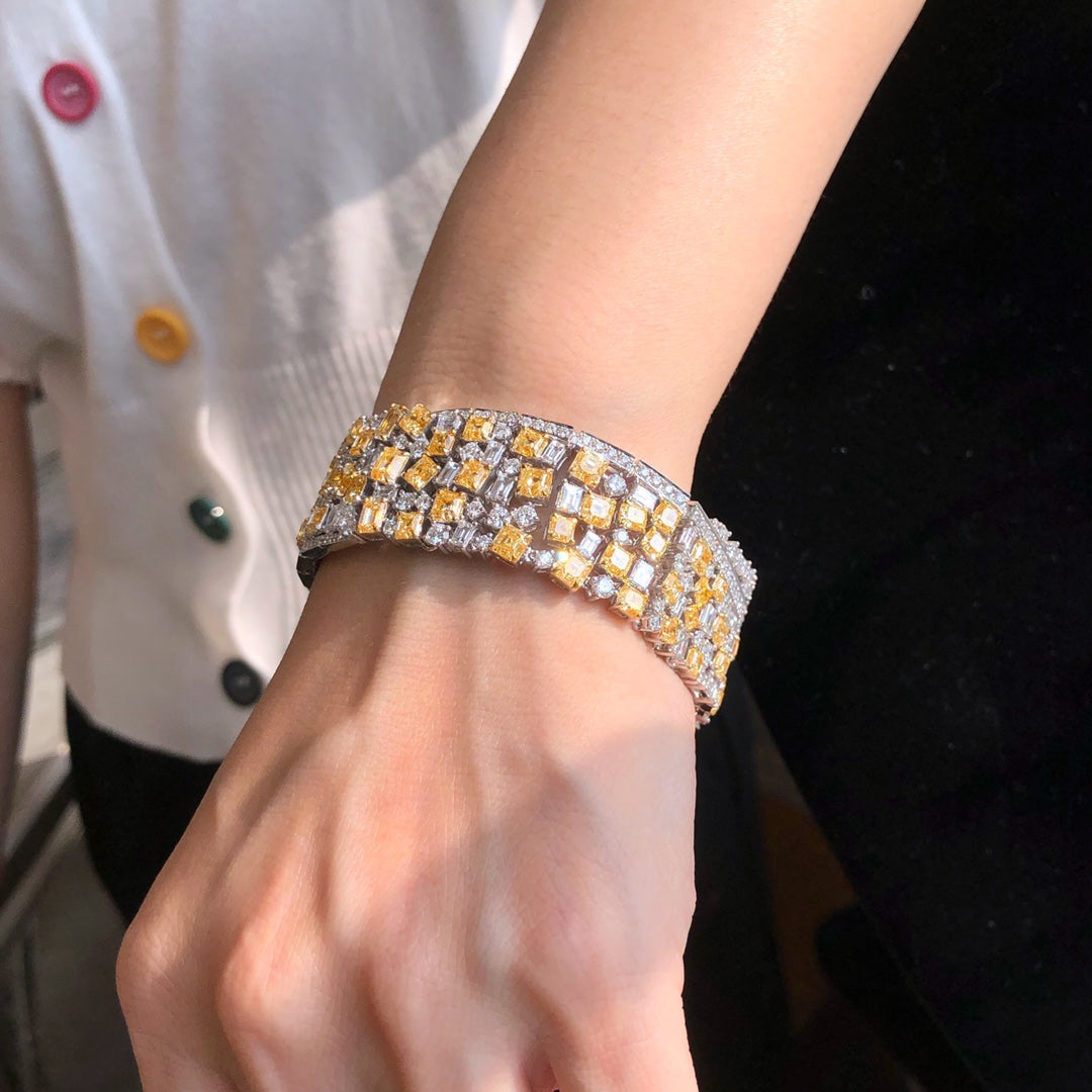 32.16ct multi-shape fancy yellow and white diamond bracelet in 18k white gold