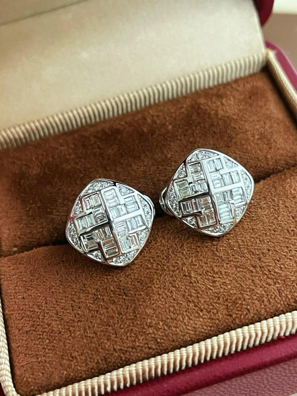Close-up of 18K white gold geometric diamond earrings