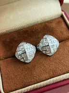 Close-up of 18K white gold geometric diamond earrings