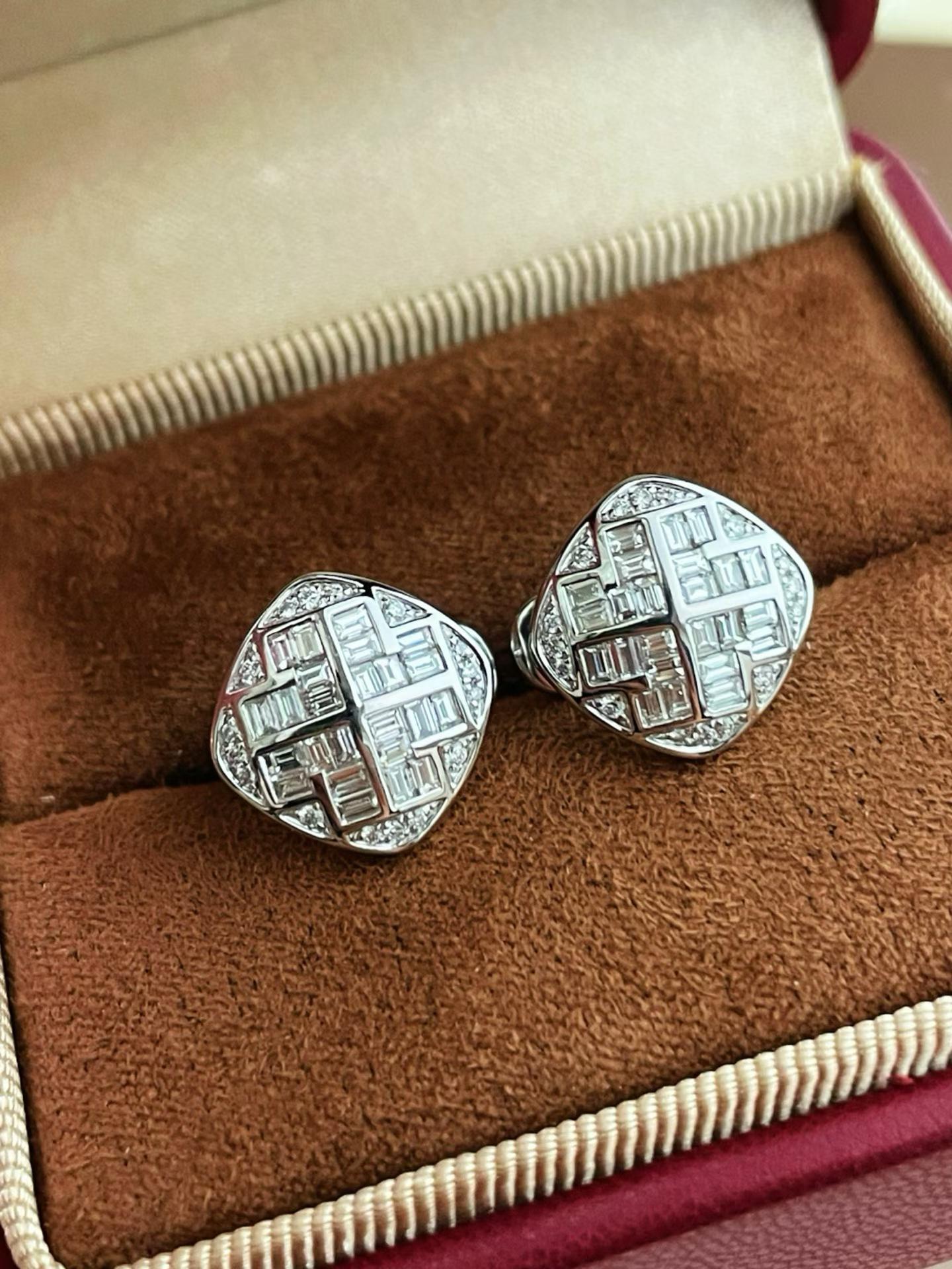 Close-up of 18K white gold geometric diamond earrings