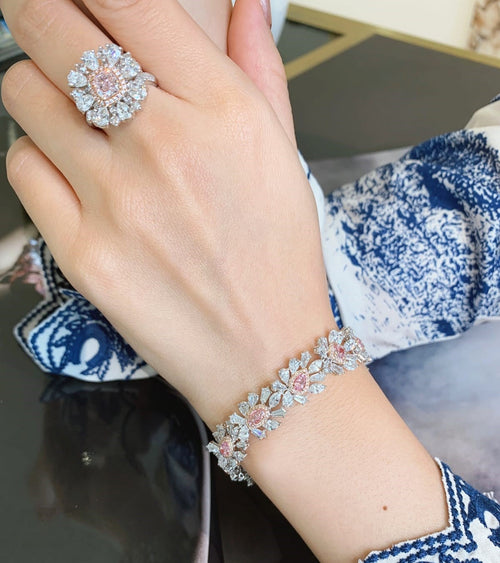 Elegant shot of the bespoke bracelet showcasing the stunning halo design and sparkling GIA Fancy Pink diamonds set in a luxurious band