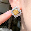 “Elegant two-tone diamond stud earrings with fancy yellow center stones”
