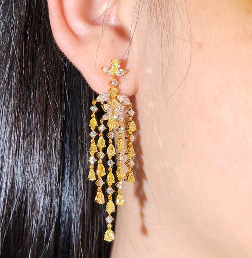  Fancy yellow and white diamond chandelier earrings with pear, round, and marquise cut stones, total weight 7 carats.