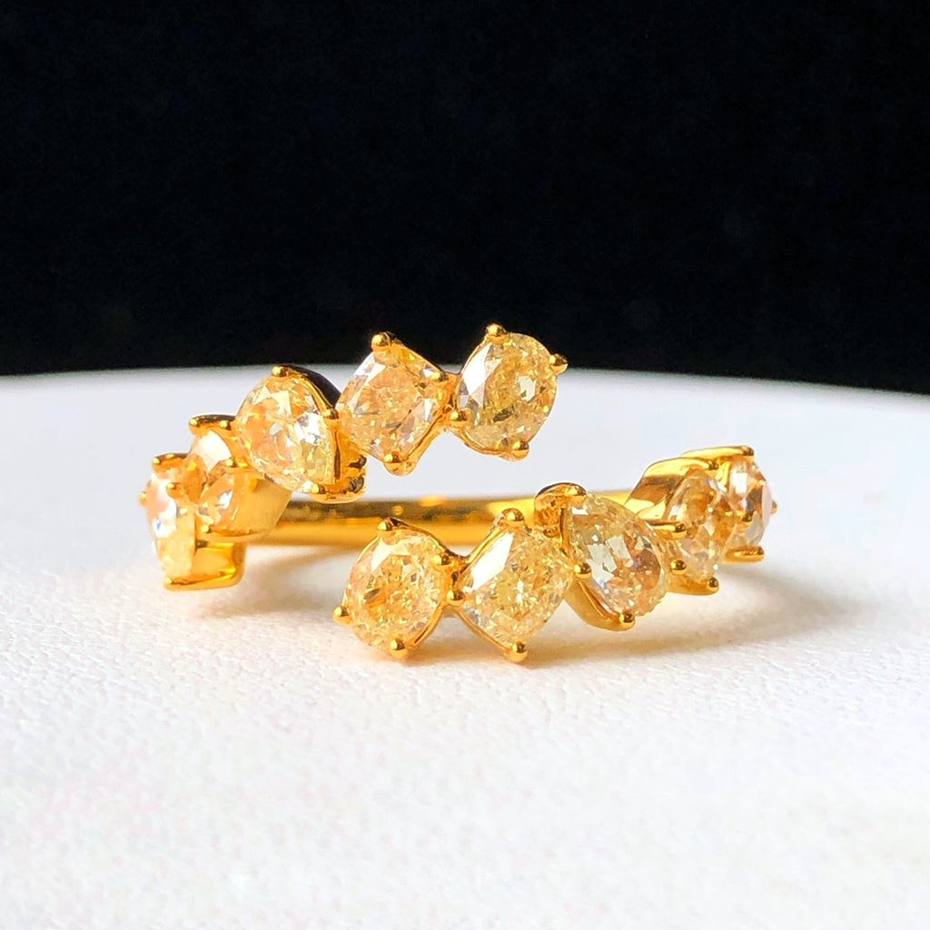 “Fancy yellow pear, oval, and square diamond ring by Eze Jewelry”
