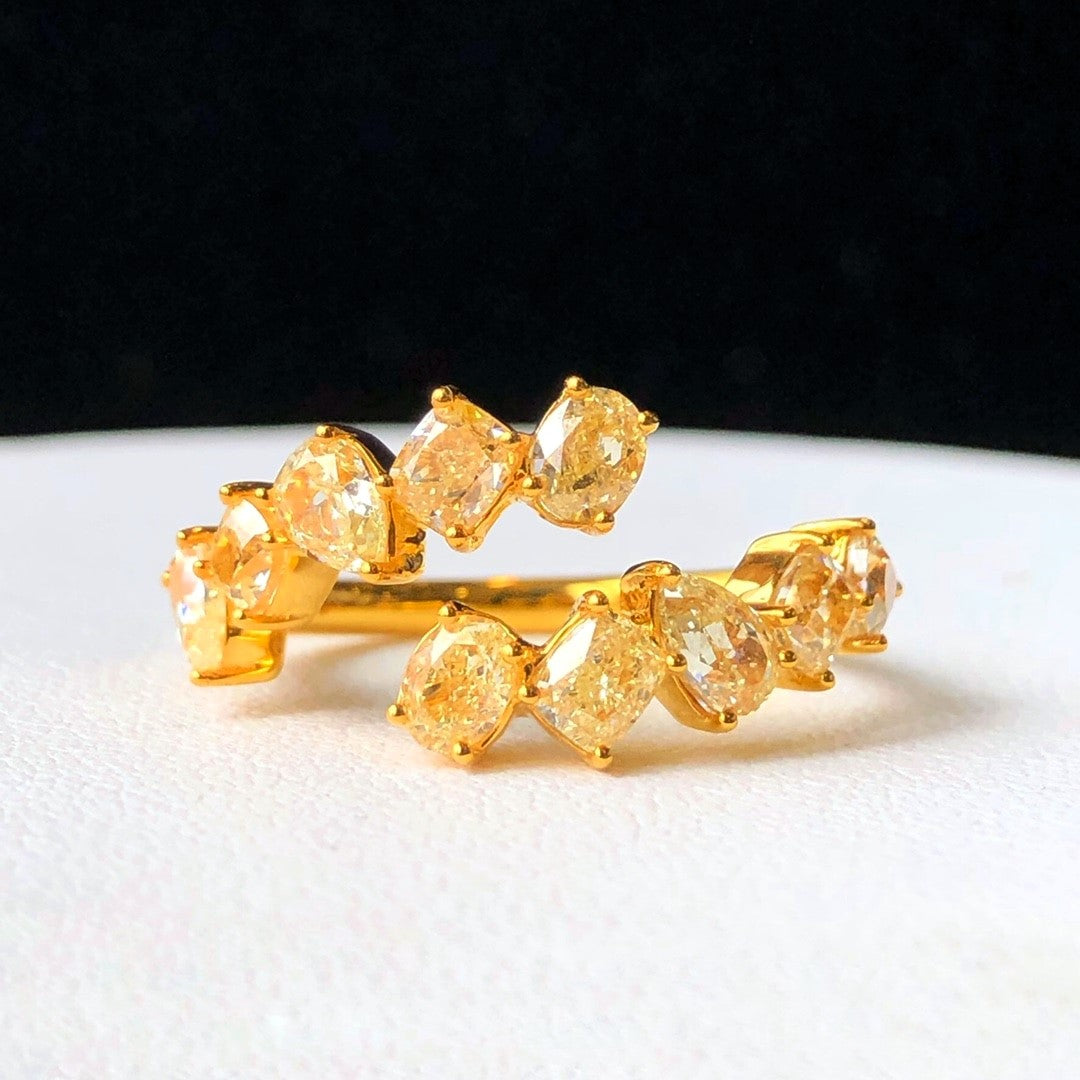 “Fancy yellow pear, oval, and square diamond ring by Eze Jewelry”