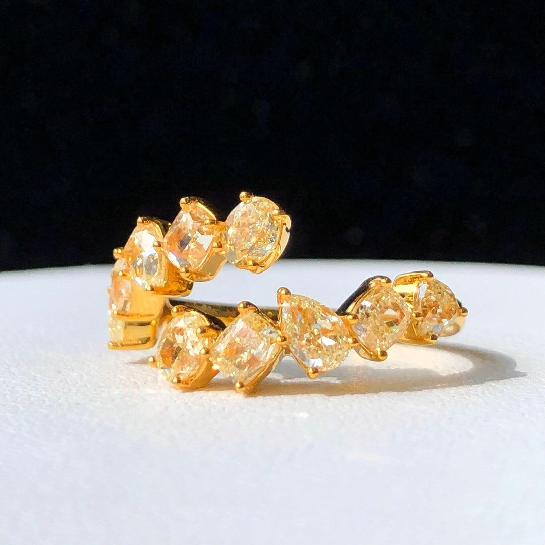 “Modern bypass ring with fancy yellow diamonds in solid gold”