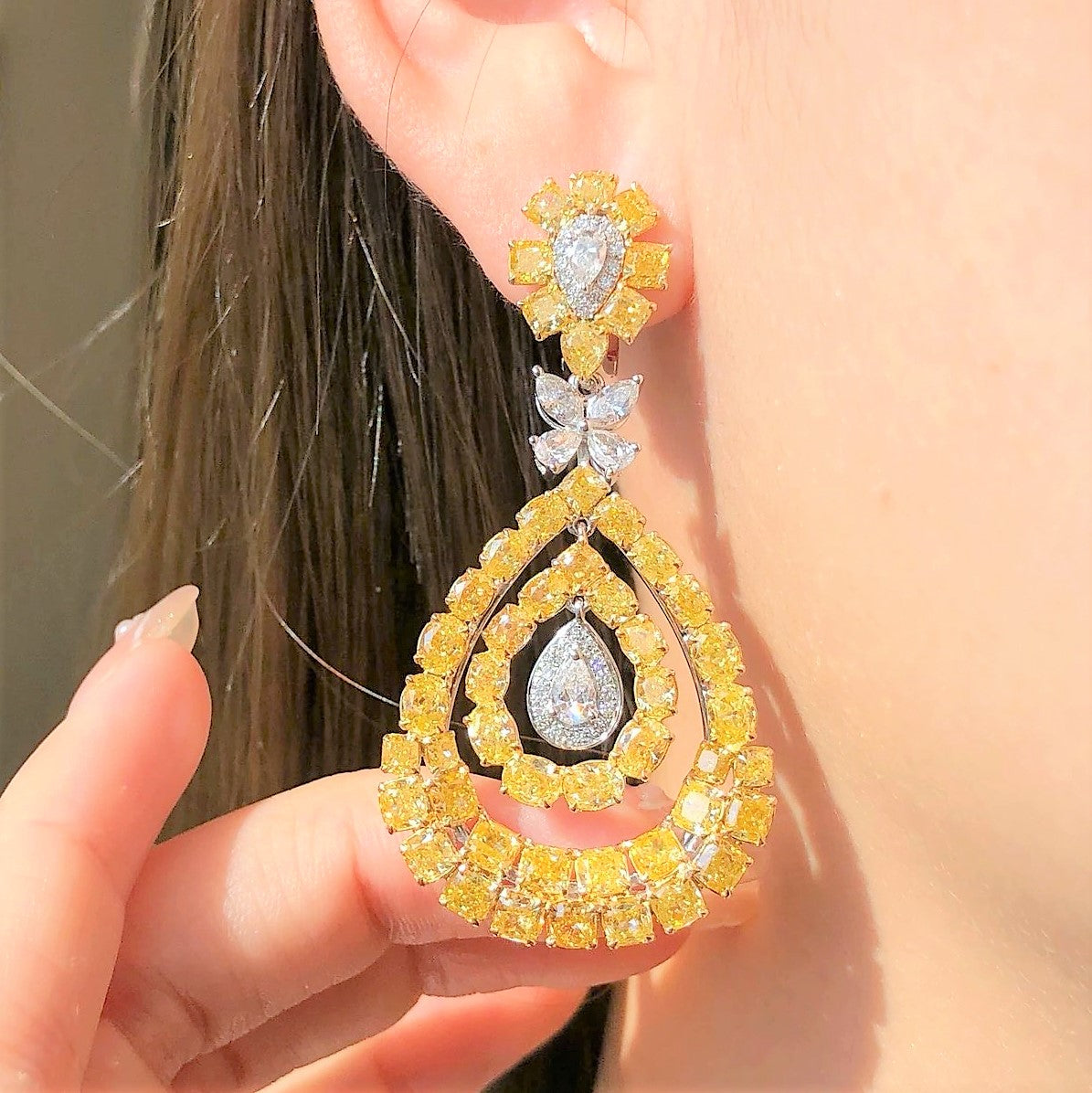 “Natural yellow diamond drop earrings with white diamonds in 18k white and yellow gold”