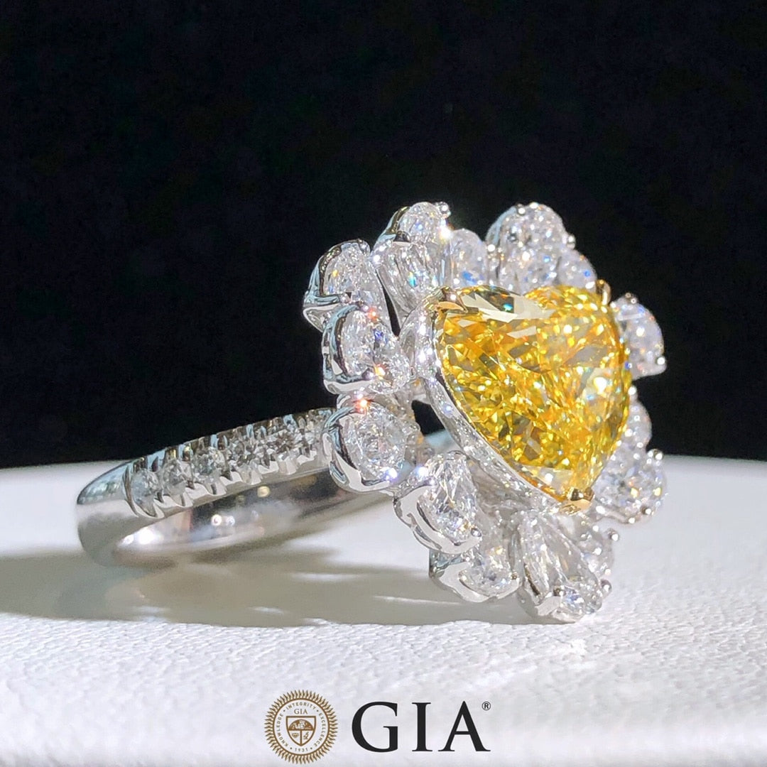  Side profile of yellow diamond halo engagement ring showcasing setting and diamond band.